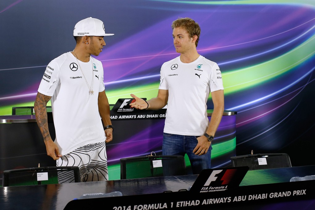 The body language between Lewis Hamilton and Nico Rosberg is not good before a posed handshake at a media conference on Thursday for Sunday's Abu Dhabi Grand Prix. Photo: EPA