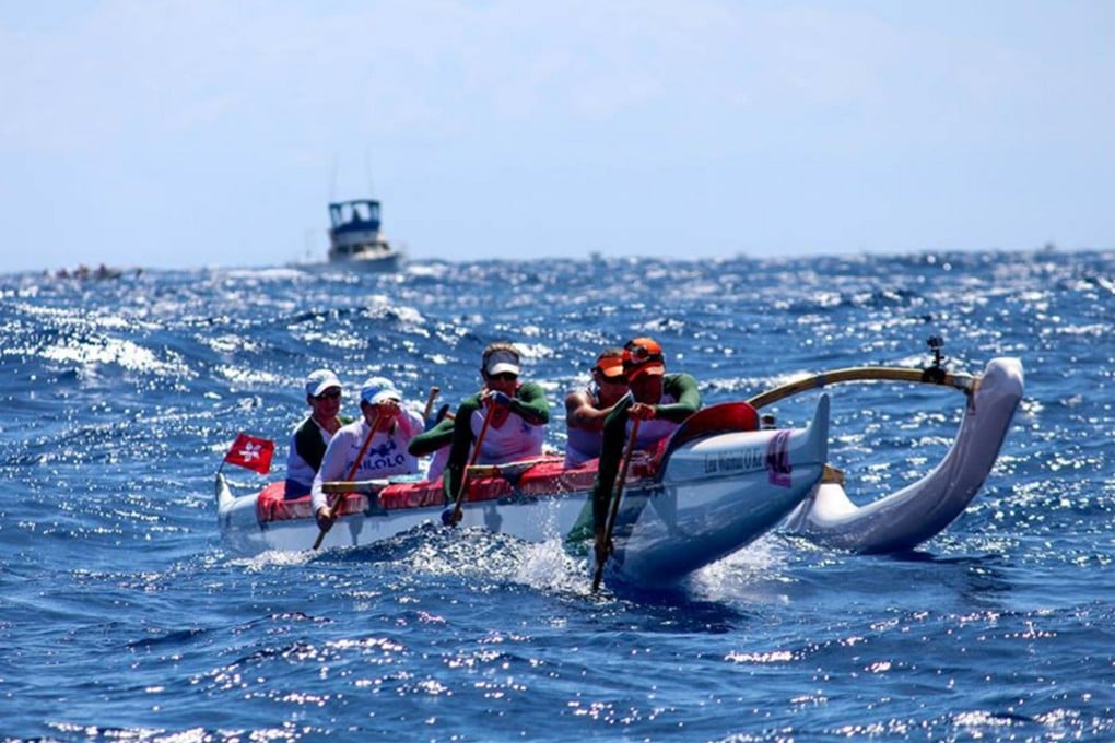 The Hong Kong Outriggers Canoe Club team in action during their race in the channel between the Hawaiian islands of Molokai and Oahu. Photo: SCMP Pictures