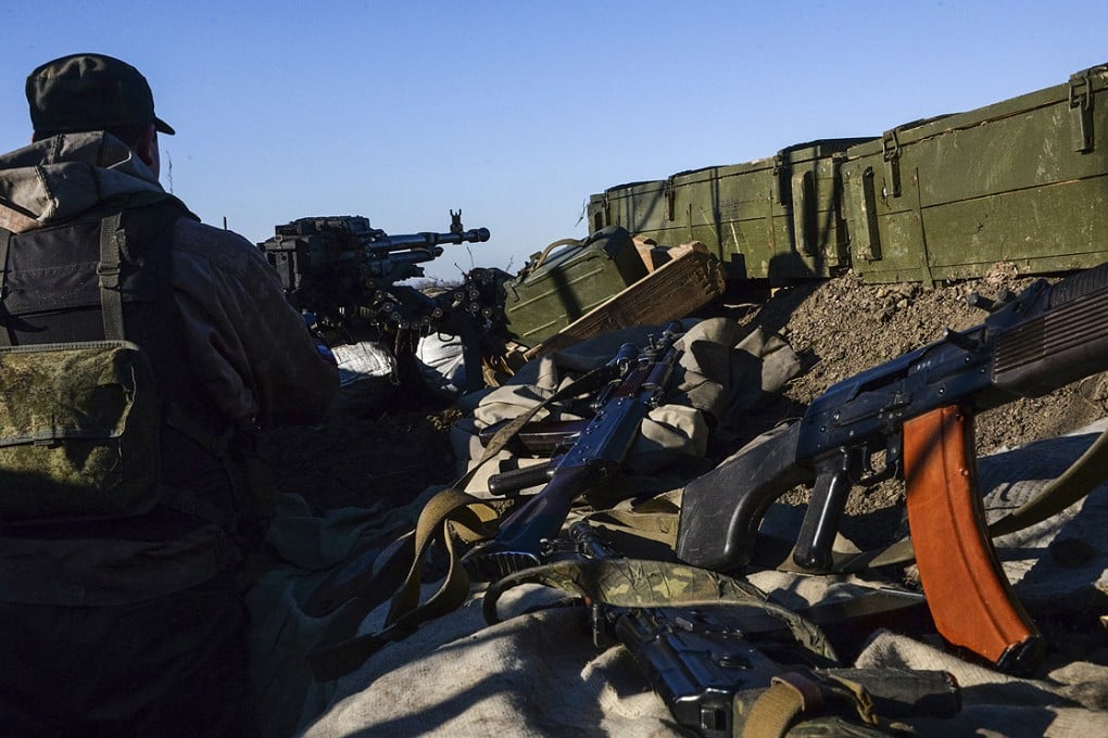 A pro-Russian rebel fires a Russian designed machine gun toward Ukrainian army positions near Donetsk on Friday. Photo: AP