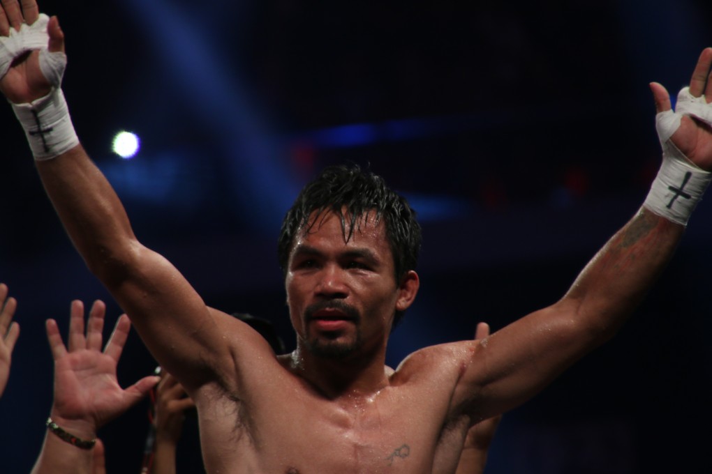 Manny Pacquiao raises his arms in triumph after easily defeating Chris Algieri at Cotai Arena. Photos: Unus Alladin