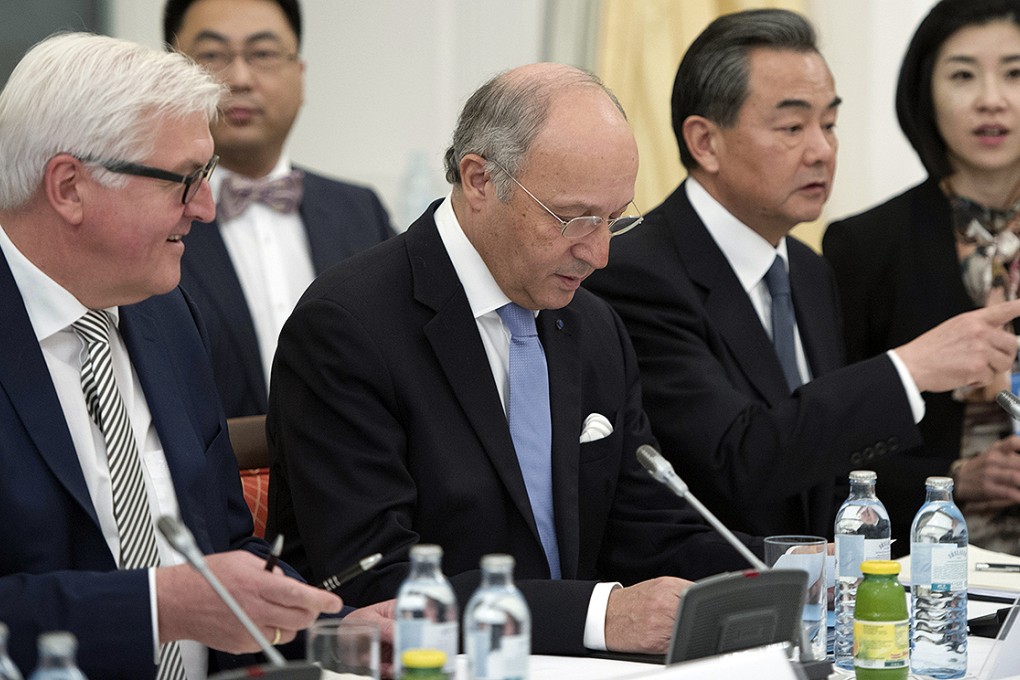 German Foreign Minister Frank-Walter Steinmeier, French Foreign Minister Laurent Fabius and Chinese Foreign Minister Wang Yi, from left, sit at the negotiation table during their talks on Iran, in Vienna. Photo: AP