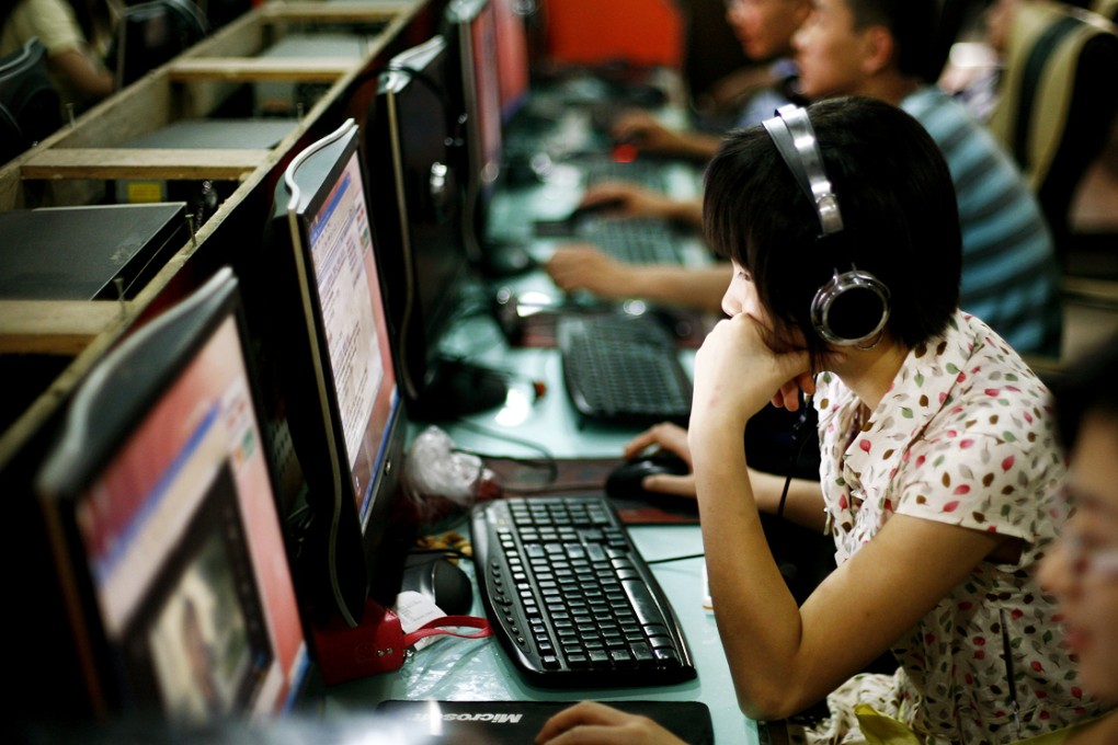 Customers surf the web at an internet cafe in Beijing. Photo:  AP