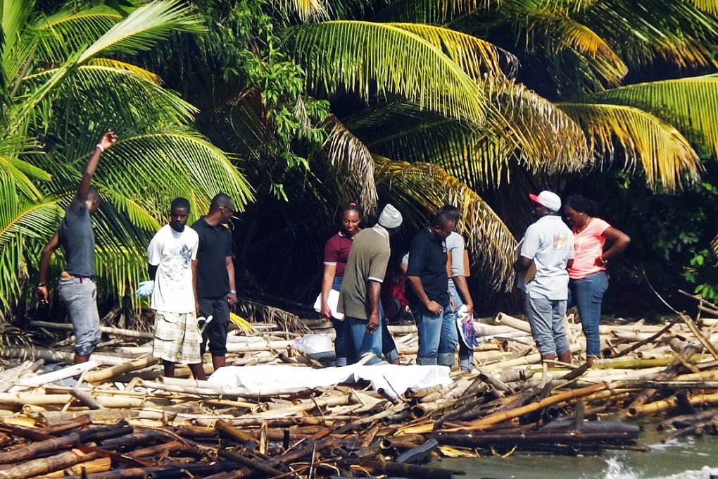 Police and forensic workers inspect the bodies of German couple Hubertus and Birgid Keil, after they were found murdered on a beach near their home in the island of Tobago. Photo: Reuters