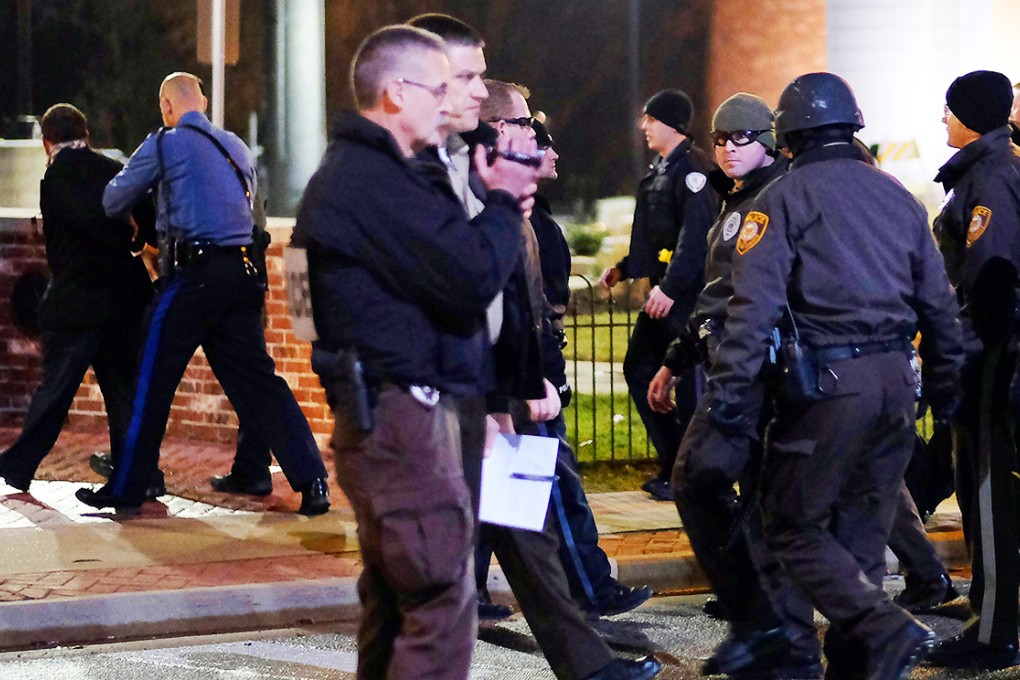 Police detain a demonstrator (far left) during protests on November 21 against the August shooting of 18-year-old Michael Brown in Ferguson, Missouri. Photo: AFP