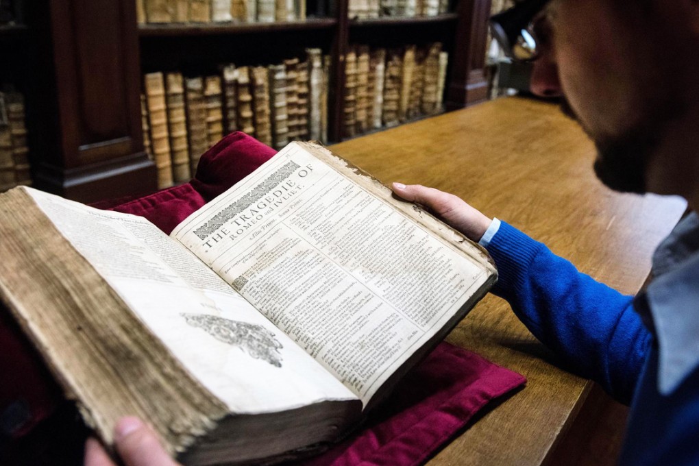 Librarian Remy Cordonnier with the First Folio he found while selecting books for an exhibition on English literature. Photo: AFP