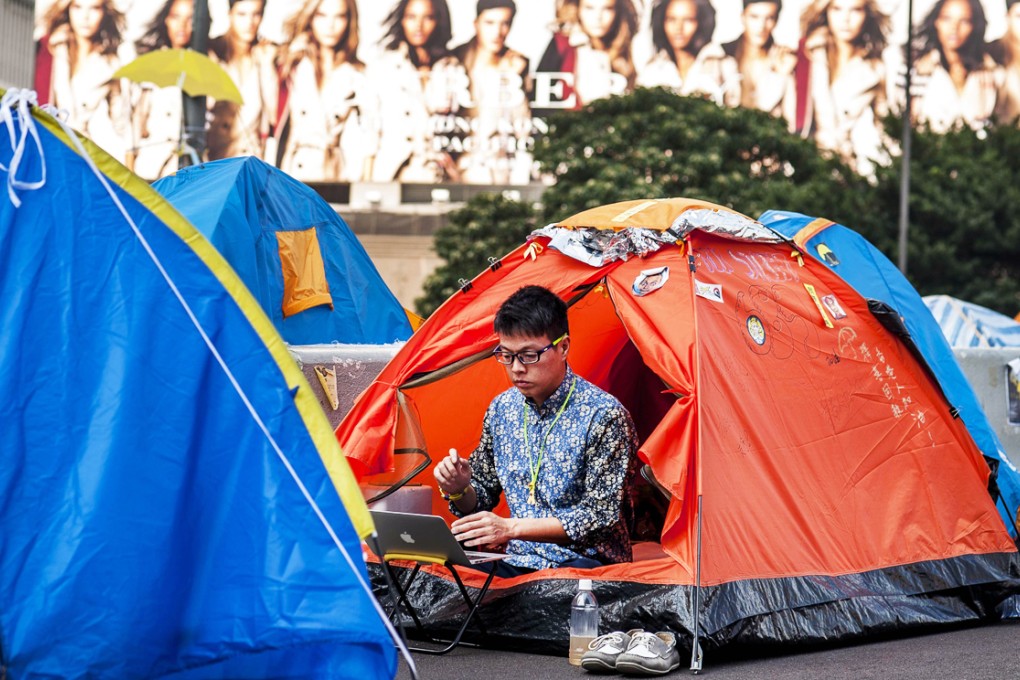A protester in Admiralty checks his laptop last month. Photo: AFP