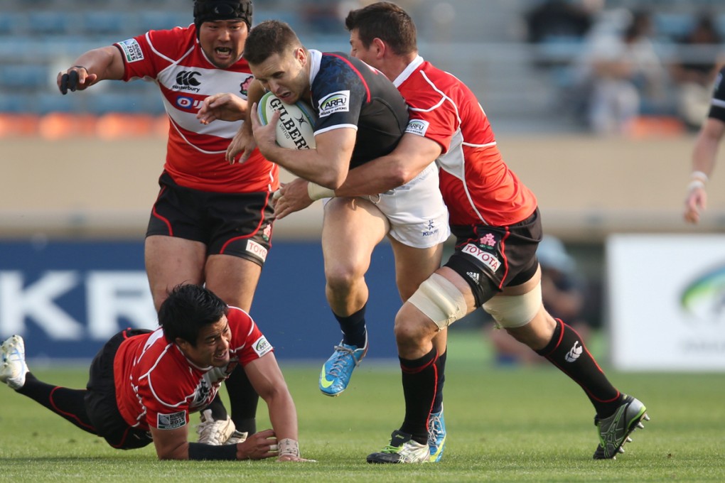 Hong Kong centre Lloyd Jones tries to break through the Japan line in a clash earlier this year. Hong Kong will get more games against the Asian powerhouses from now on. Photo: SCMP Pictures