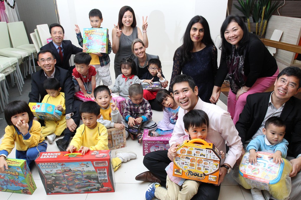 Credit Suisse employees with Benji's Centre founders (far right) Viola and Raymond Wong at their Sham Shui Po branch. Photo: May Tse