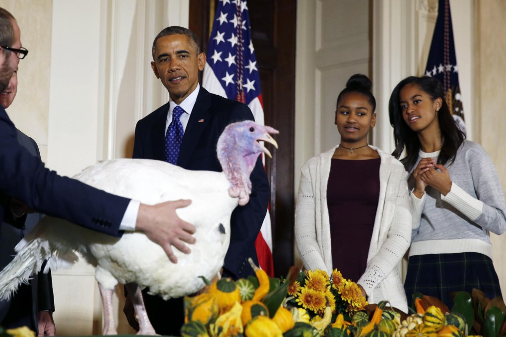 Barack Obama is joined by daughters Sasha and Malia (right) at the pardoning ceremony. Photo: Reuters