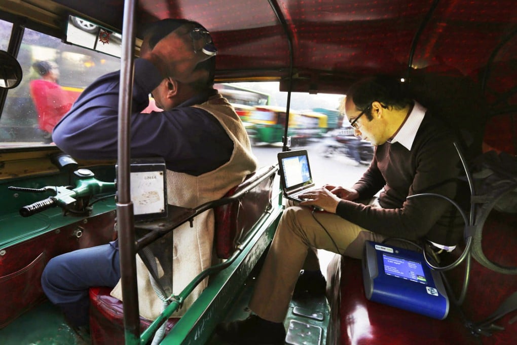 Scientist Joshua Apte monitors pollution on his laptop as he travels in an auto-rickshaw during rush-hour traffic in New Delhi. Photo: AP