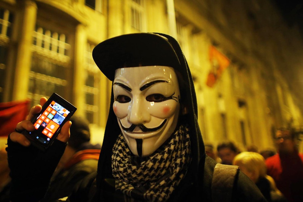 A protester holds his mobile phone during a protest against new tax on Internet data transfers in centre of Budapest. Photo: Reuters