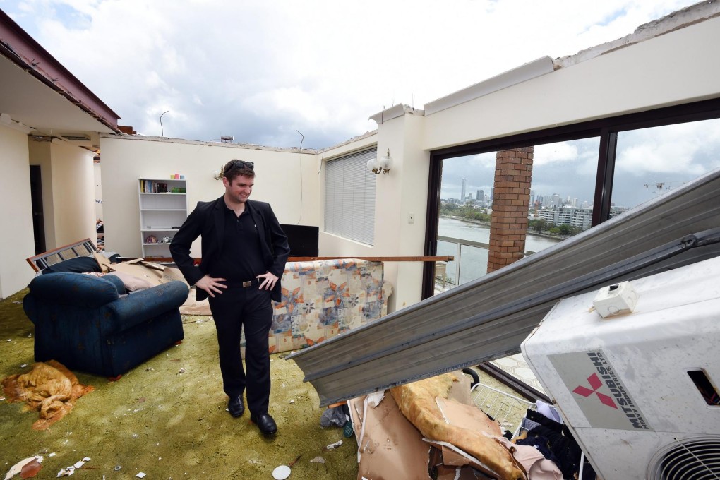 James Marriott surveys his damaged apartment. Photo: EPA