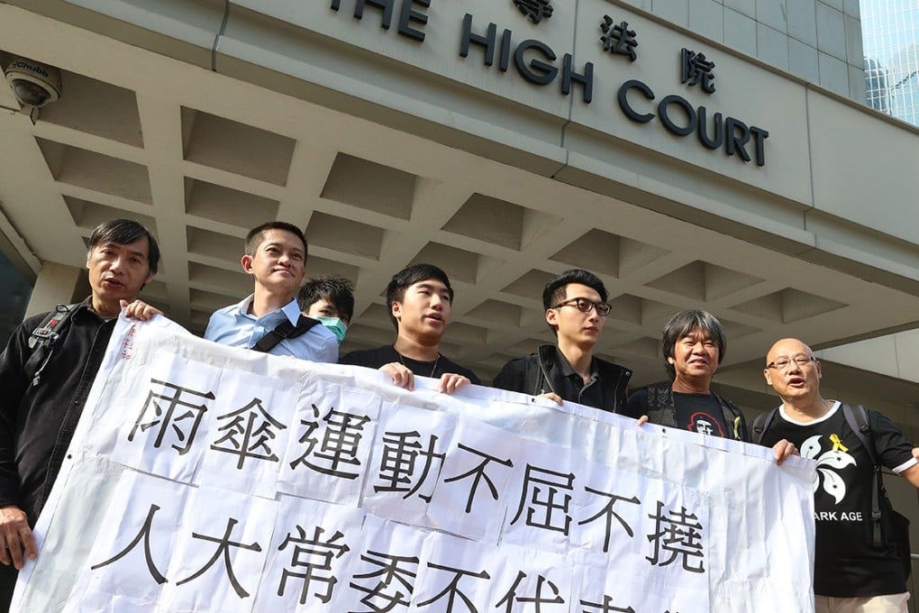 Umbrella Movement supporters including lawmakers Leung Kwok-hung and Albert Chan Wai-yip, protest outside High Court, while the court deals with criminal contempt cases involved in the Mong Kok injunctions. Photo: K. Y. Cheng