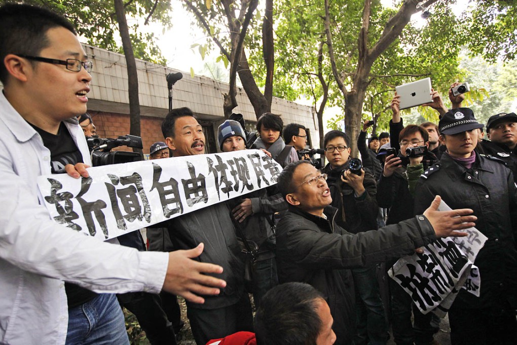 A protest against censorship outside the Southern Weekly newspaper's Guangzhou headquarters, in January, which involved one of the two activists now on trial, Guo Feixiong. Photo: AP