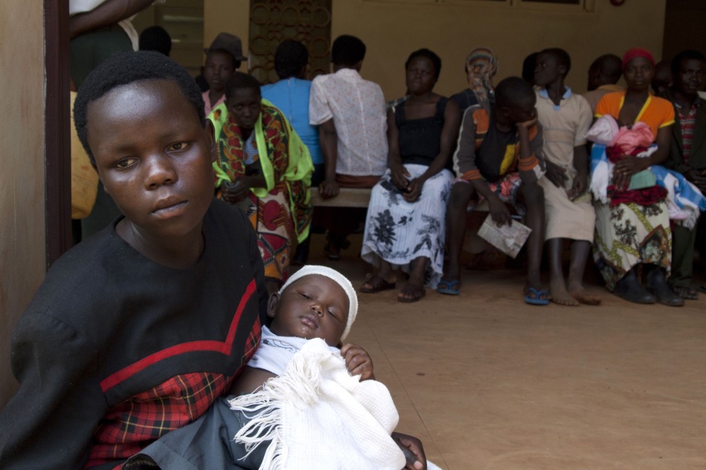 Women queue to get their babies tested for HIV in Uganda. Photo: AFP