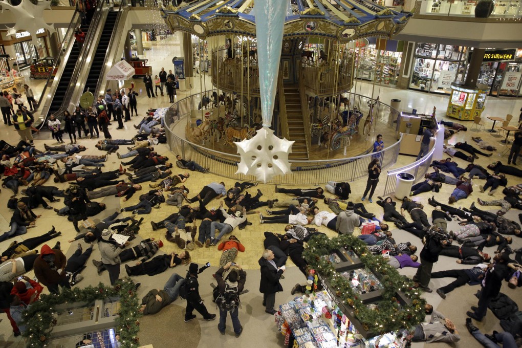 Protesters lie on the floor inside a shopping mall near Fergsuon in Missouri. Other protests were held across the US. Photo: AP