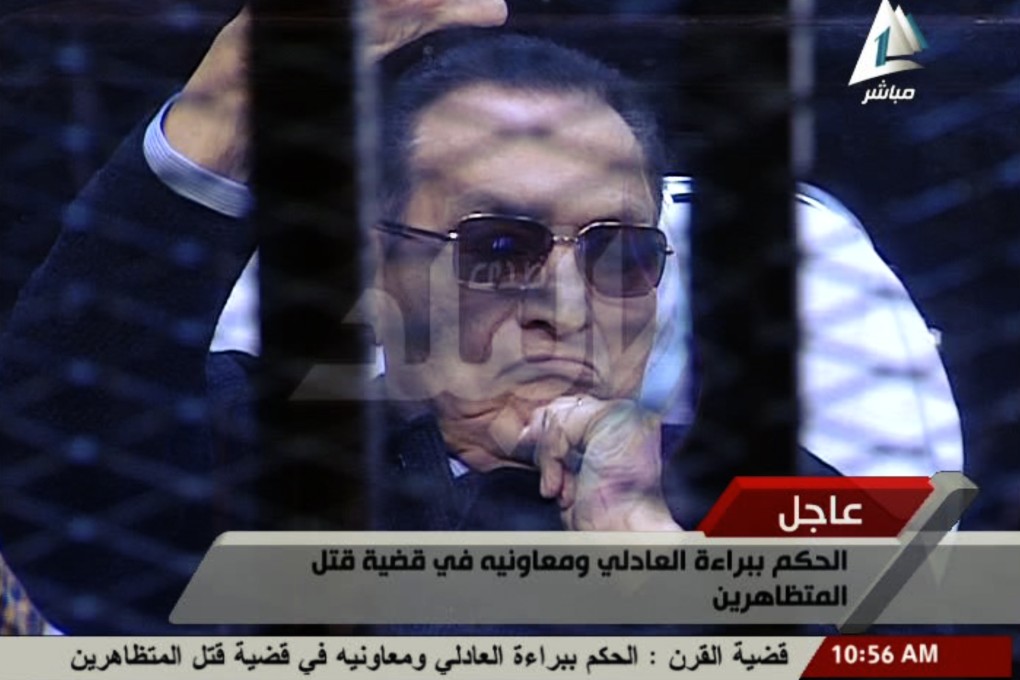 An image from Egyptian state television shows Hosni Mubarak sitting in the defendant's cage in court on Saturday.