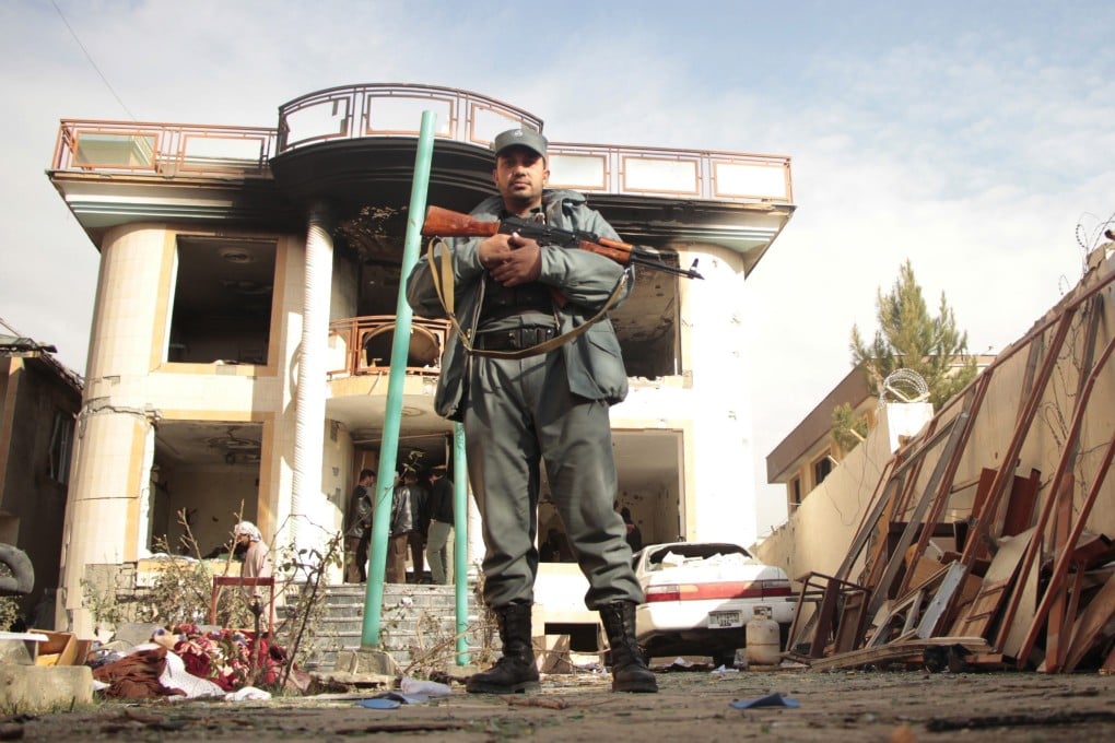 An Afghan soldier guards the Kabul guest house. Photo: EPA