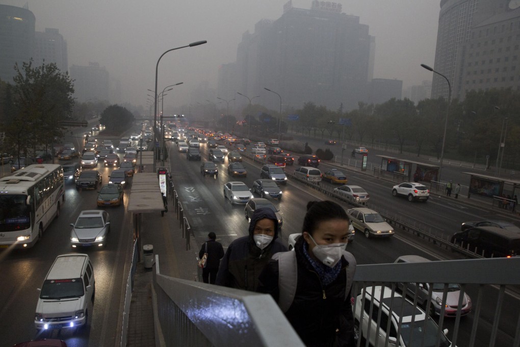 Pedestrians wear masks to protect themselves as heavy smog returns to the capital. Photo: AP