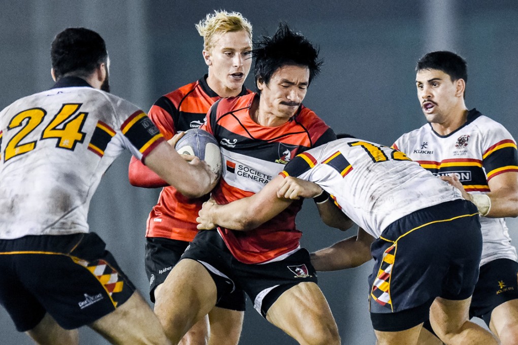 Valley winger Salom Yiu Kam-shing fends off HKCC centre Danny Atamu during the match at Aberdeen Sports Ground. HKCC won 3-0. Photos: HKRFU