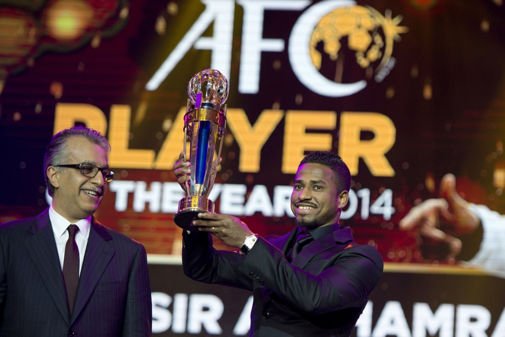 Al Hilal striker Nassir al-Shamrani holds his Asian Football Confederation (AFC) Player of the Year trophy together with AFC president Sheikh Salman bin Ebrahim al-Khalifa during the AFC's 60th anniversary and annual awards held in Manila. Photo: AFP