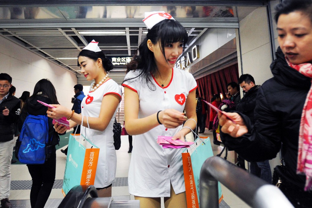 Chinese aids activists hand out condoms in a subway station in Wuhan, Hubei. Photo: AFP