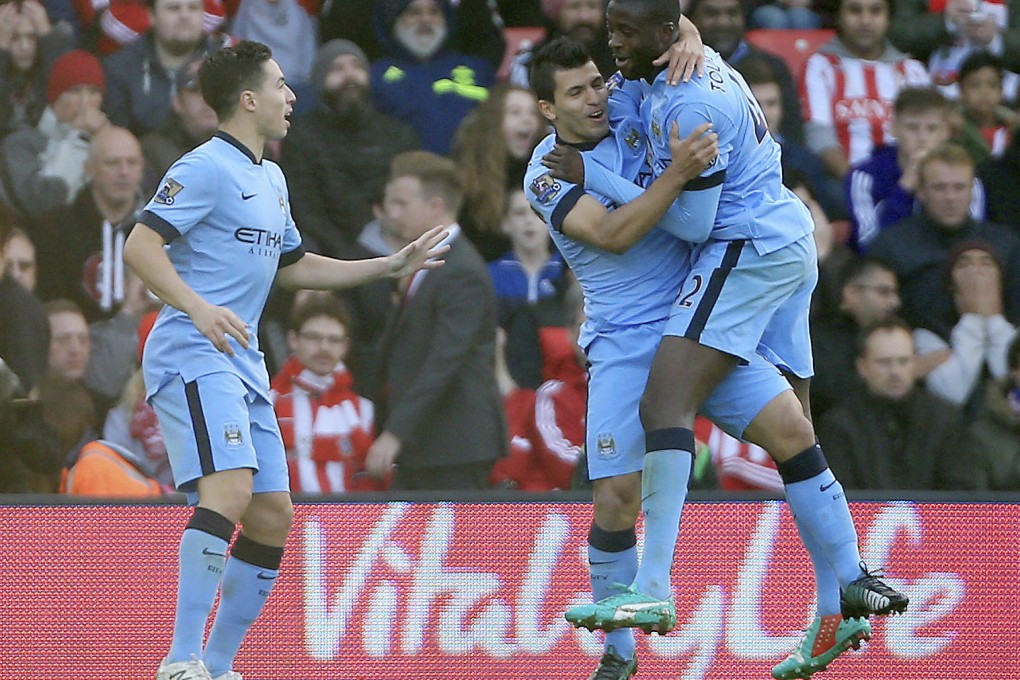 Yaya Toure celebrates City's first goal with Sergio Aguero as Samir Nasri also joins the party. Photo: AP