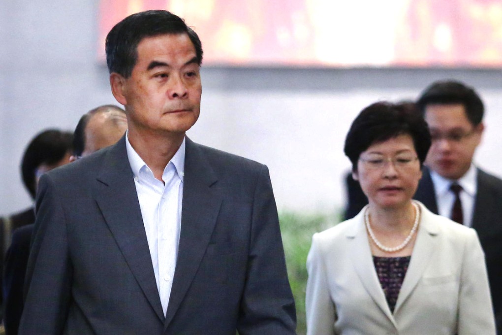 Leung Chun-ying and Carrie Lam leave a meeting yesterday.