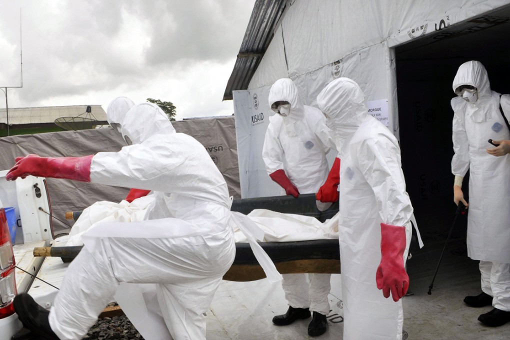 Body of a suspected Ebola victim is moved in Liberia. Photo: AP
