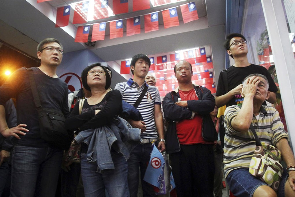 The tension of yesterday’s local elections in Taiwan shows on the faces of supporters of the Democratic Progressive Party as they watch results roll in. Photo: AP
