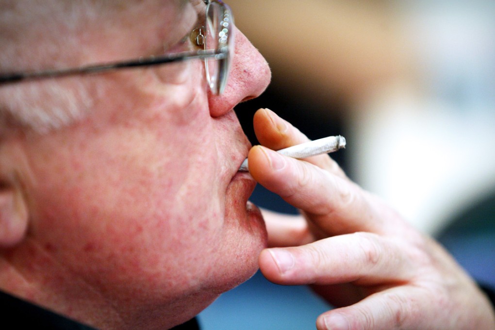A British man smokes in Cricklewood Broadway, north London.
