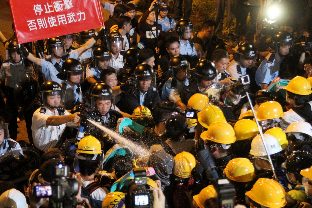 Police clash with protesters in Tamar. Some legislators are accused of letting activist leaders work in their offices. Photo: Edward Wong