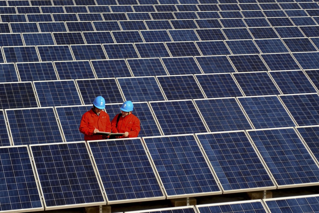 Workers check solar panels in China. The sale of GCL-Poly Energy's solar wafer business should help the company reduce its finance costs and raise funds. Photo: AP