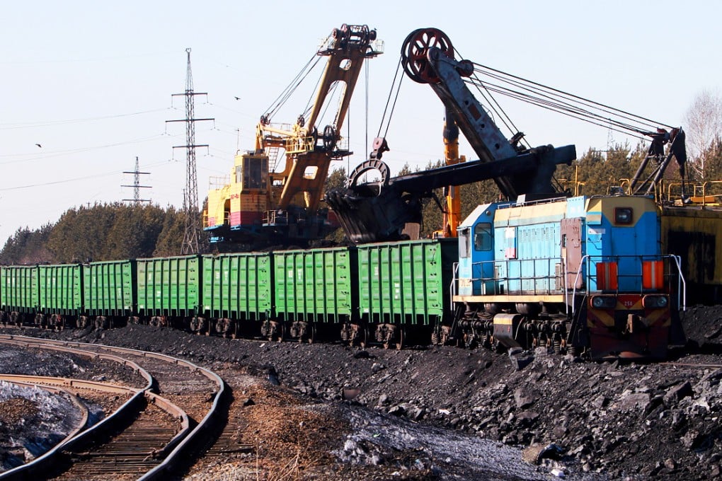 Excavators load coal into train wagons near Kemerovo, Siberia, Russia.