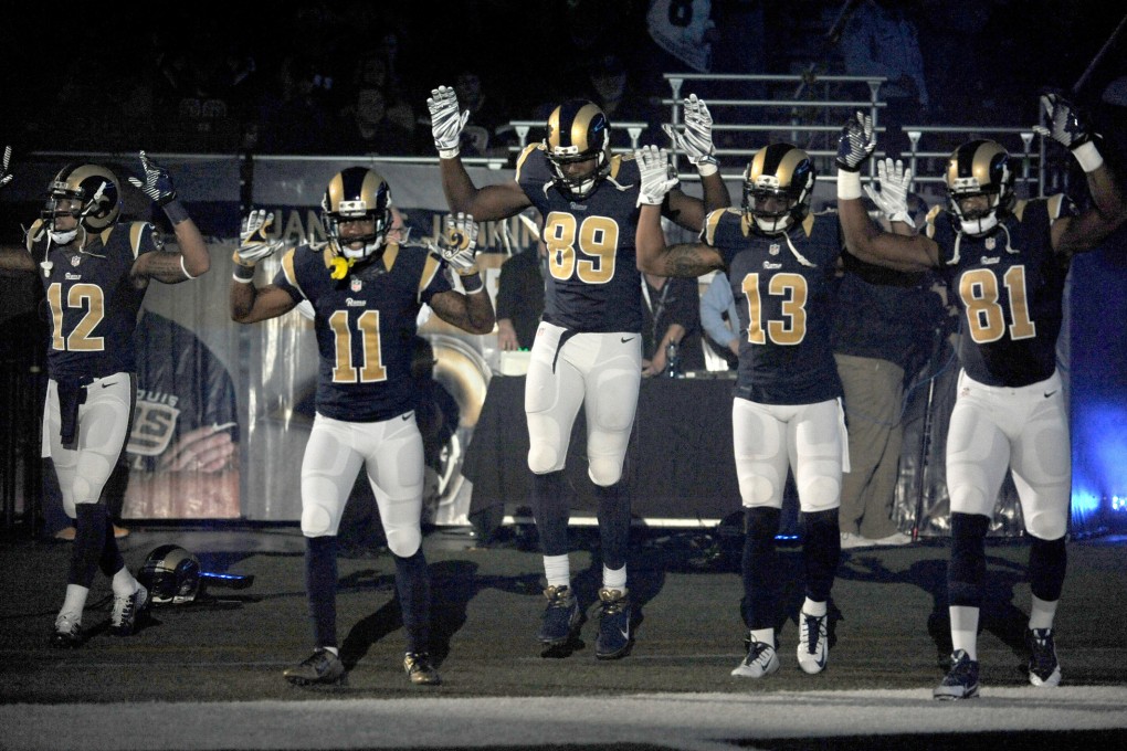 The Rams players make the 'hands up don't shoot' gesture. Photo: AP