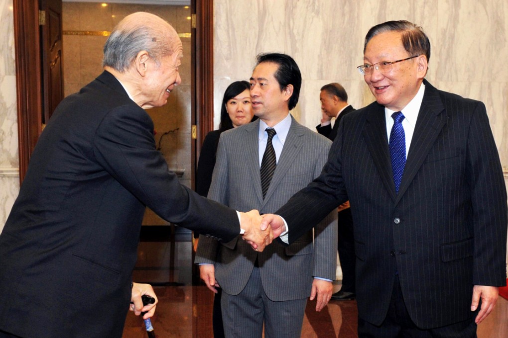 Former state councillor Tang Jiaxuan (right) meets Japan Post Holdings President Taizo Nishimuro as the New Japan-China Friendship Committee for the 21st Century gather at the Diaoyutai State Guesthouse in Beijing on Wednesday. Photo: Kyodo