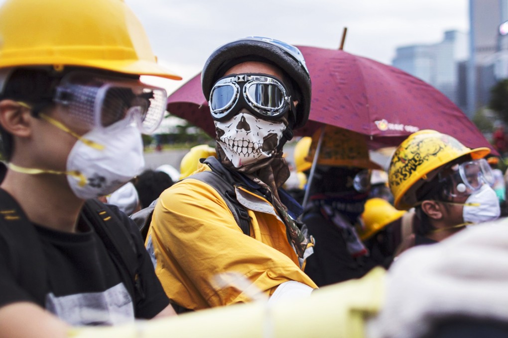 Pro-democracy protesters occupy Lung Wo Road, next to the Hong Kong Chief Executive's Office, part of the Central Government Office complex that the protesters are trying to surround. Photo: EPA