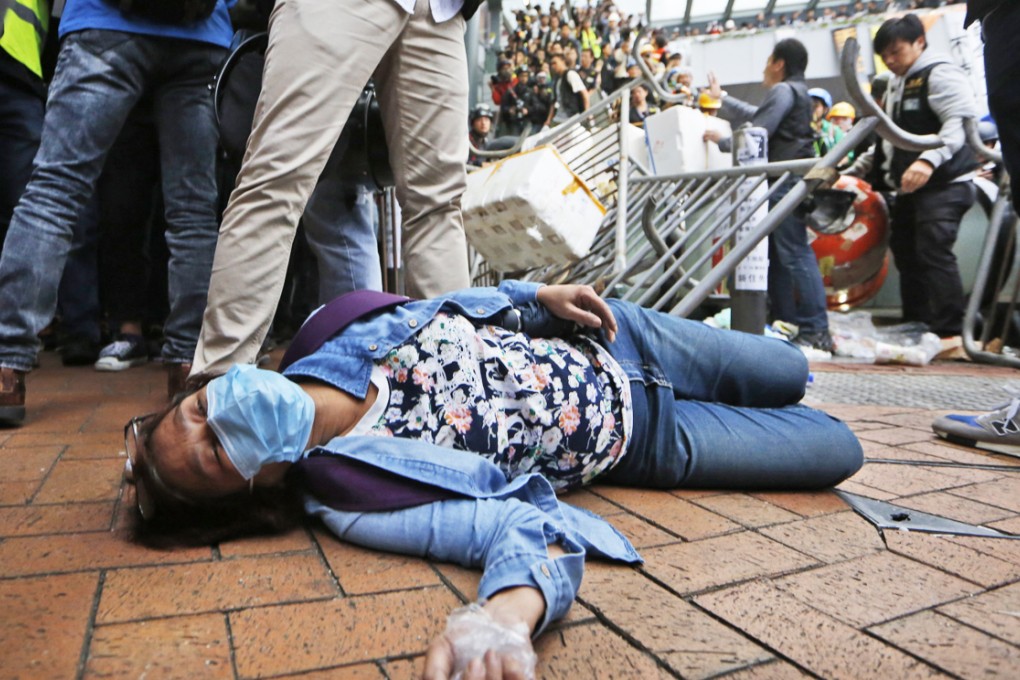 An injured protester lies on the ground during clashes on Monday. Photo: AP