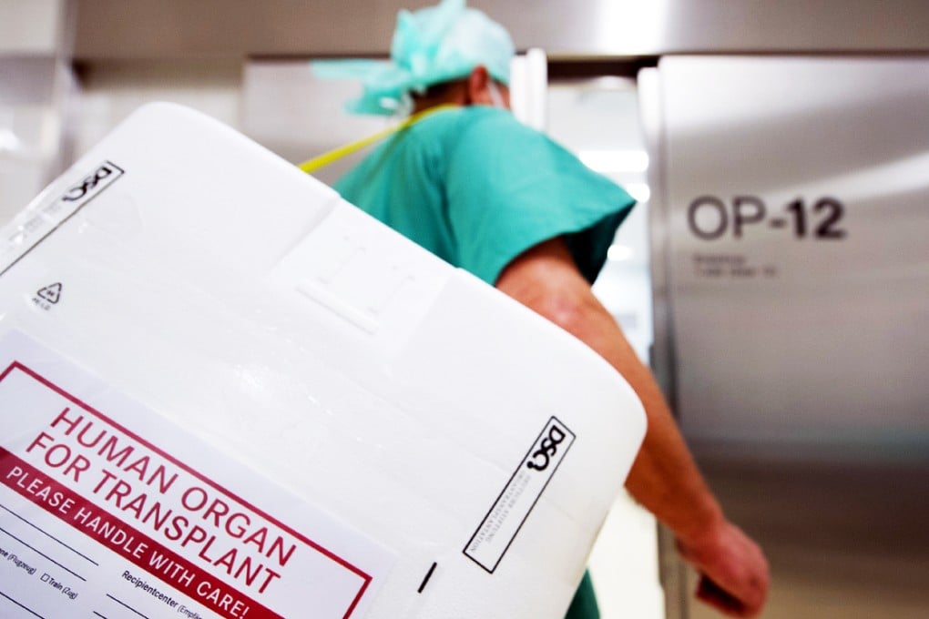 A doctor carries a container used to transport donated organs. China has one of the lowest voluntary organ donation rates in the world.