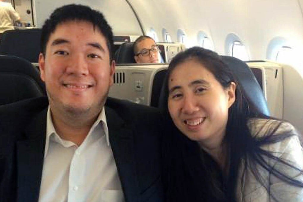 Cleared American couple Matthew and Grace Huang smile onboard an airliner bound for the United States. Photo: AP