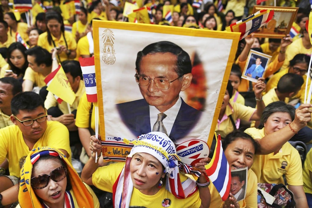 Well-wishers wearing royal yellow gather outside the Bangkok hospital where King Bhumibol Adulyadej is being treated. Photo: Reuters