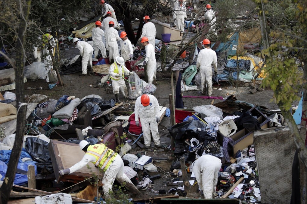 Crews begin to clear the homeless camp. Photo: AP