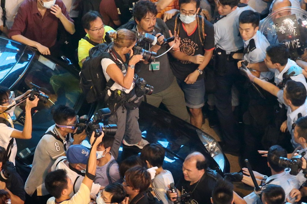 Paula Bronstein stands on the car in Mong Kok. Photo: K.Y. Cheng