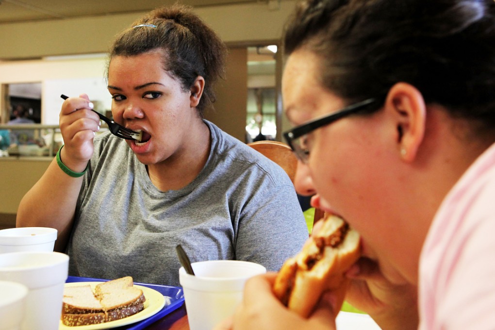 Seventeen year-old Marissa Hamilton watches a friend eat during a meal at Wellspring Academy in Reedley, California. Photo: AFP