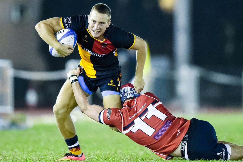 HKCC Winger Tom McQueen powers through a tackle by David Whiteford of HK Scottish during their clash on October 25. When the two teams meet at The Rock on Saturday, Christmas bragging rights and the Broony Quaich will be up for grabs. Photo: HKRFU