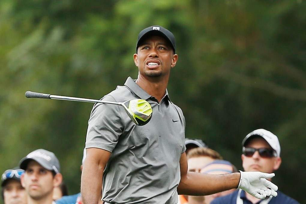 Tiger Woods tosses a club in frustration. Photo: AFP