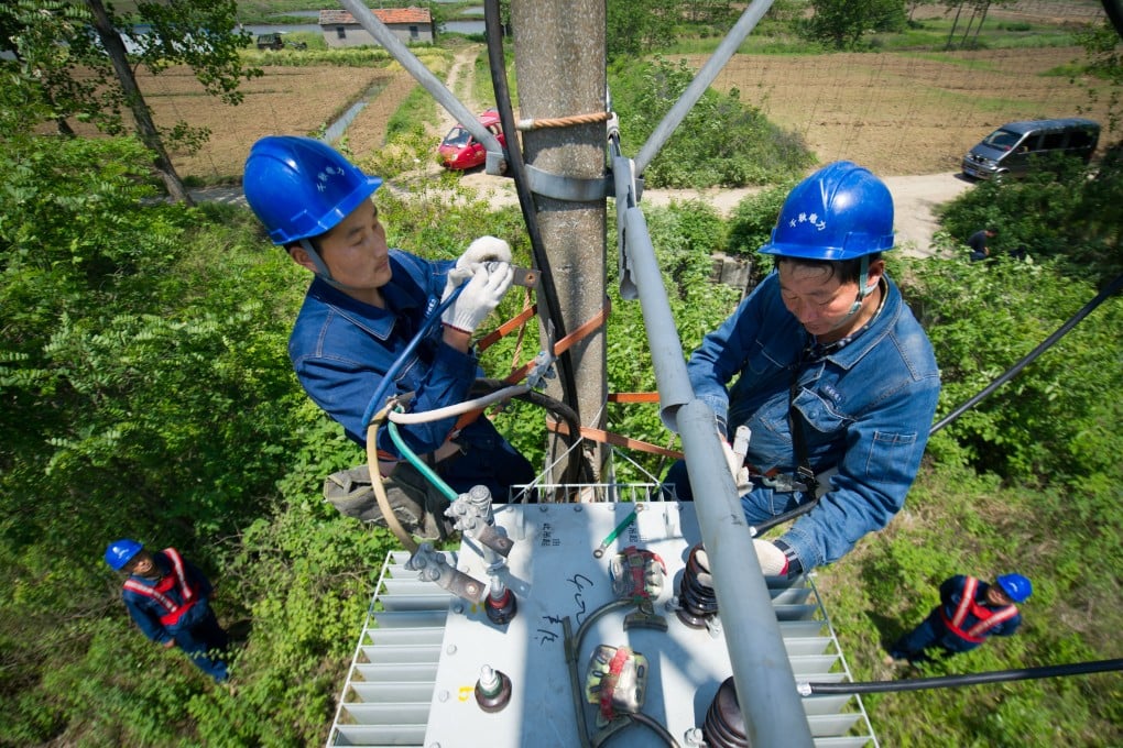 State Grid workers install a transformer in Anhui province. Photo: Xinhua