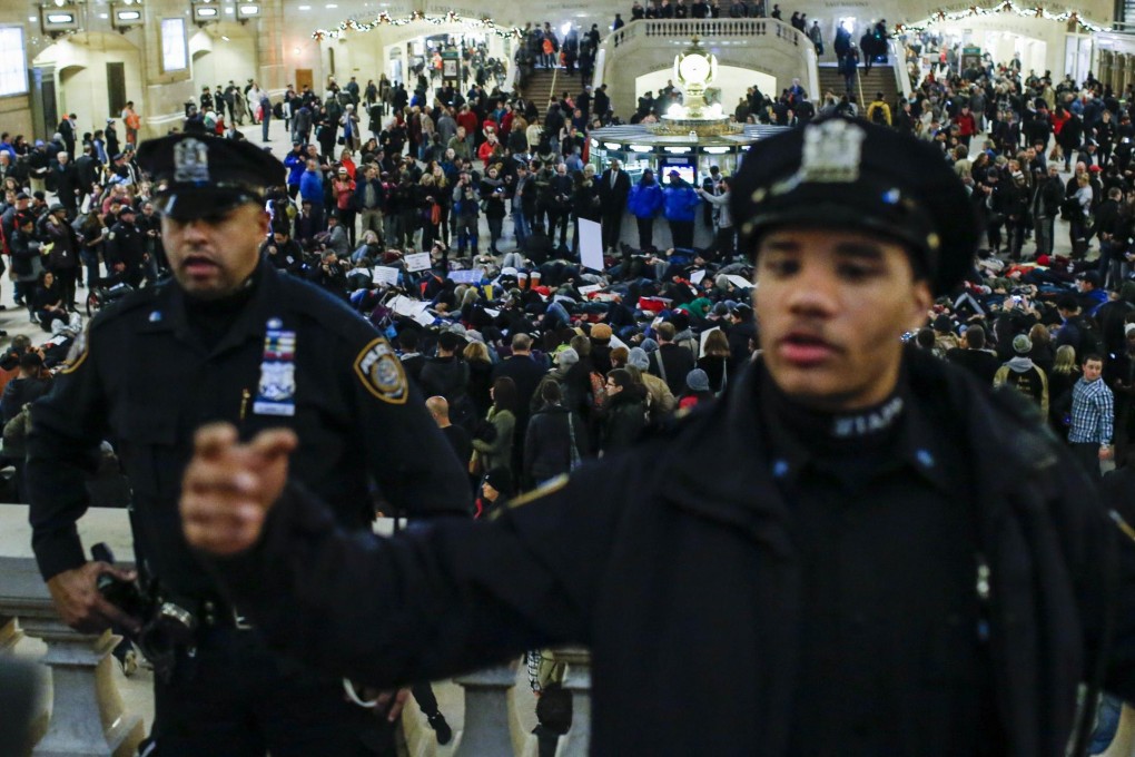 New York police officers watch demonstrators at Grand Central station. Photo: AFP