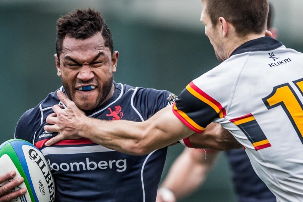 Inside centre Lex Kaleca of HK Scottish carries the ball into battle against HKCC fullback Jason Kjestrup. Photos: HKRFU