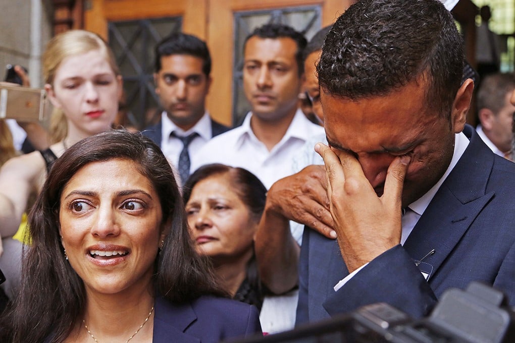 Ami Denborg, left, and her brother Anish Hindocha, right, react after the court case that acquitted their sister's former husband Shrien Dwani from murdering her at the High Court in Cape Town. Photo: AP